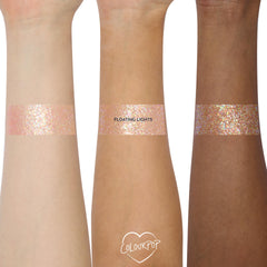 Floating Lights glitter gel from the Disney Tangled and ColourPop Collection swatched on three skin tones, showing the iridescent pink and gold sparkles of this Back In Stock ColourPop full collection set shade.