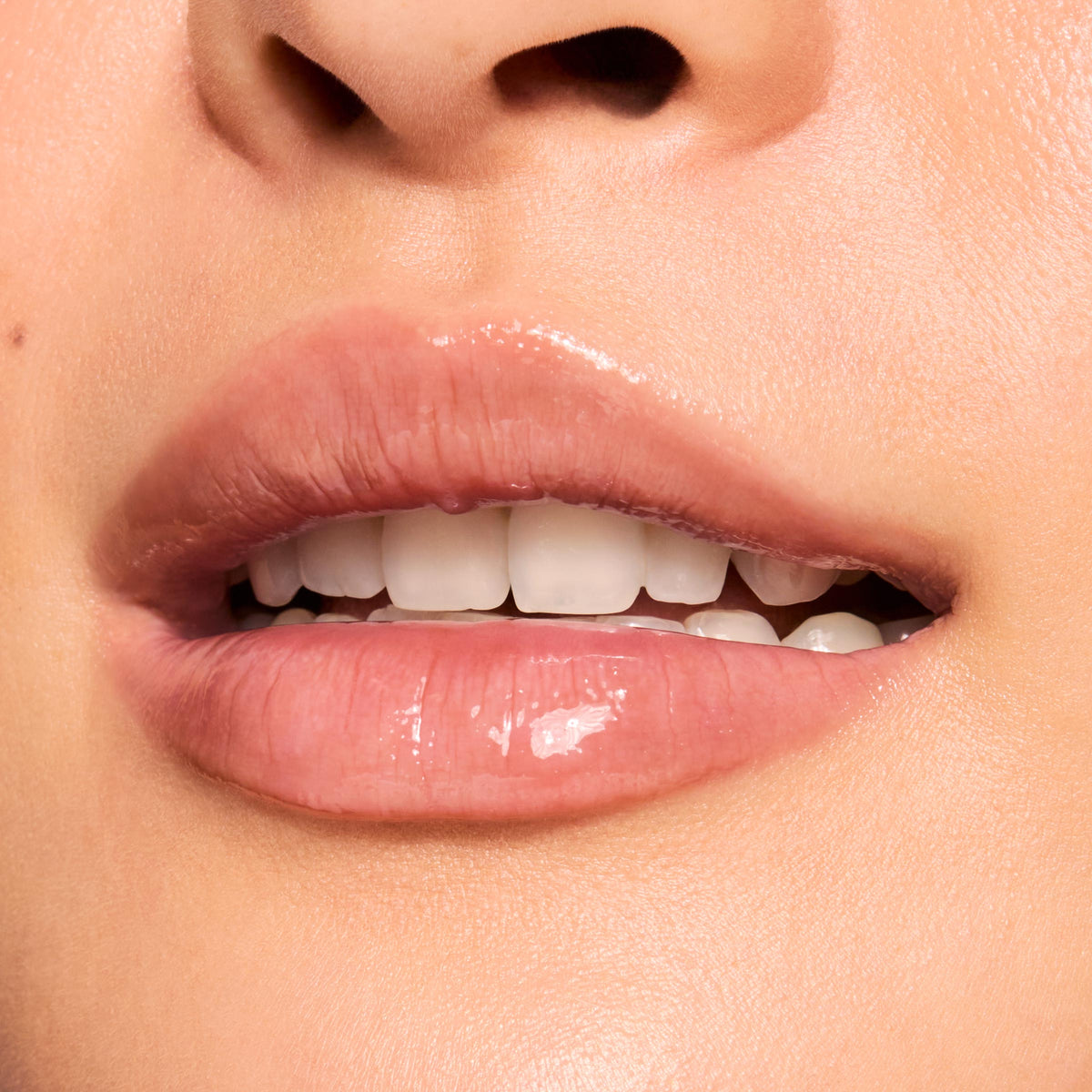 Glossy, slightly parted lips wearing ColourPop Fresh Kiss Glossy Balm in Chocolate Milkshake, showing a sheer cocoa-nude tint and high-shine, cushiony finish; macro close-up highlighting smooth, hydrated texture.