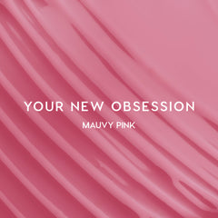 Heart to Get Sorry Not Sorry blush + UGL set swatched in smooth mauvy pink stripes, showing creamy, highly pigmented color payoff against a glossy pink background for modern US makeup lovers.