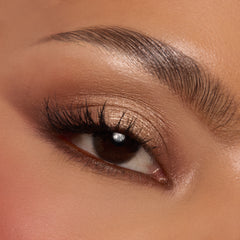 Shimmery champagne and warm mocha eyeshadows sweep across a single eyelid with fluttery lashes, showcasing the Deja Brew ColourPop Shadow Palette; neutral brown tones softly blended on lid and crease for a wearable soft‑glam look in a close-up.