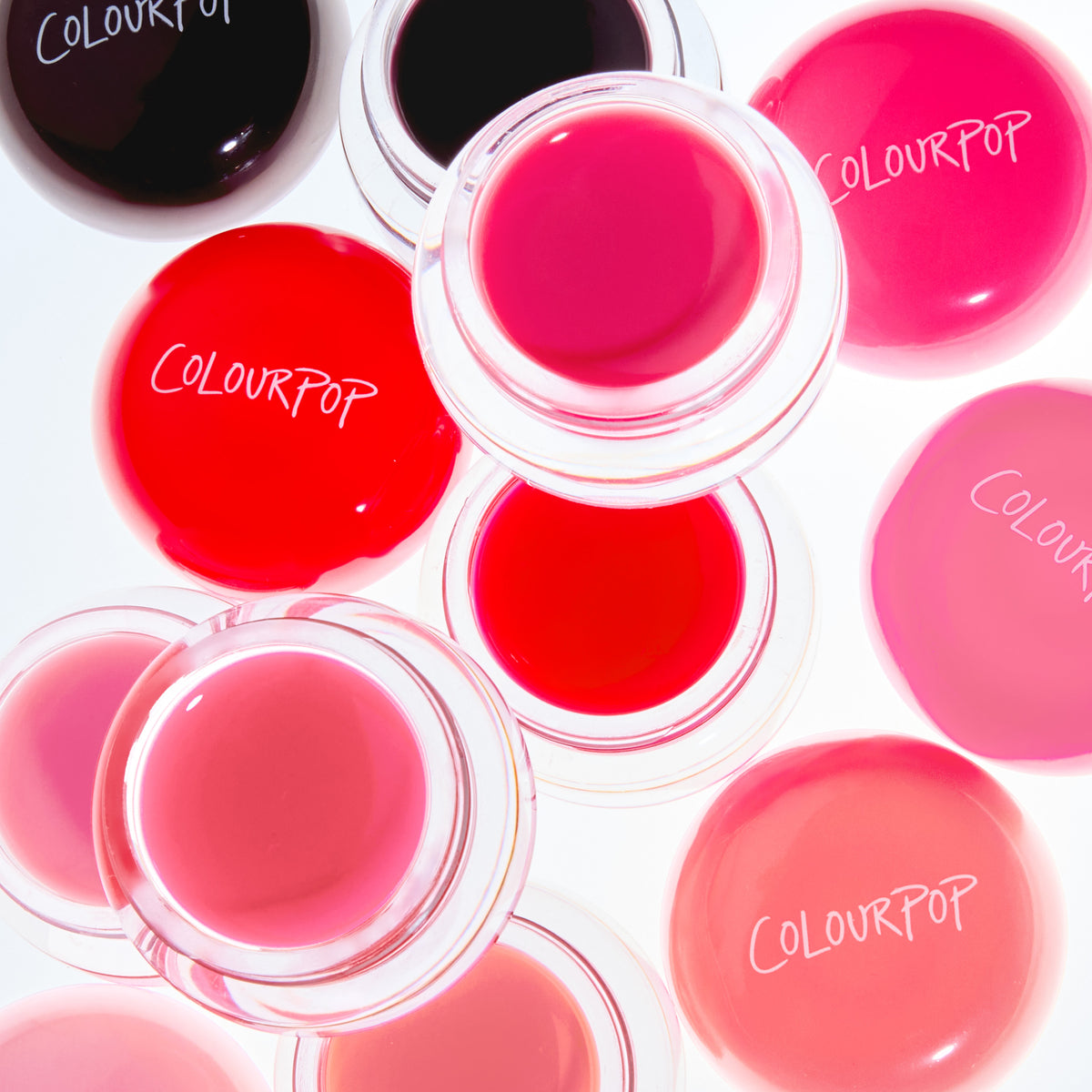Open pots of Jelly Glow Lip & Cheek Jelly in berry, pinks and reds from above