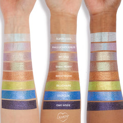 Arm swatches display ColourPop Jelly Much Shadow Sage Bundle on three forearms, with labeled shades Super Cool, Hallucinogenius, Big Ego, Shiny Penny, Brentwood, Billionaire, Stargaze, and Emo Inside, showing metallic color payoff from icy white to cobalt and plum.