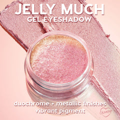 Open jar of ColourPop Jelly Much Shadow, Buzzy, gleams with duochrome pink-to-gold metallic shimmer, resting on matching swatches over a blush-pink backdrop; gel eyeshadow formula shows vibrant pigment and reflective, long-wear sparkle.