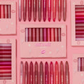 ColourPop Lippie Stix Just A Kiss set showcases lip crayon shades - pink, mauve, and red - arranged in rows with the boxed kit centered on a blush-pink background decorated with lips and lightning icons, gift-ready makeup vault.