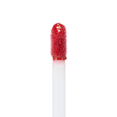Doe-foot applicator coated in rich rosy-red lip color, displaying the Keep It Classy Ultra Blotted Lip shade from the ColourPop Ultra Blotted Lip line, upright against a clean white background to highlight texture and pigment.