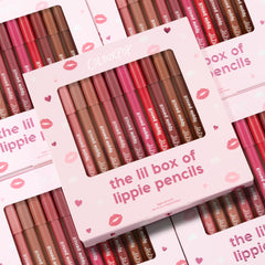 ColourPop Lippie Pencil set presenting The Lil Box of Lippie Pencils, a multi-shade lip liner kit displayed in a pink box with a clear window; pencils in nude, pink, and red tones lined up, with stacked kiss-print packaging in the background.