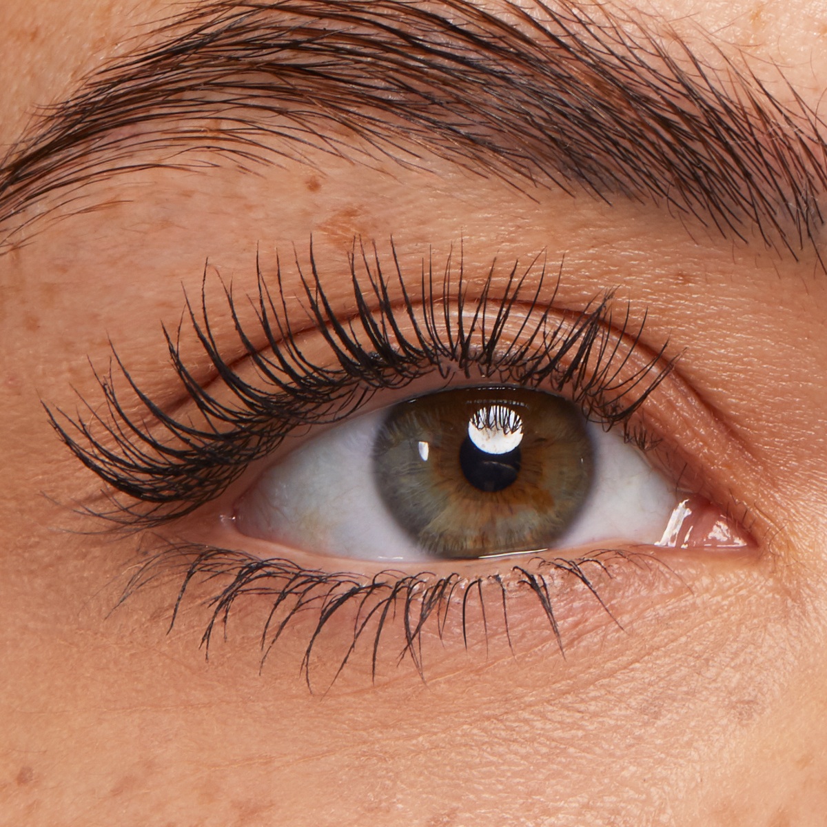 Long, separated lashes coated in Black ColourPop Lengthening Mascara, fanning upward on a close-up hazel eye, highlighting dramatic length and definition with a clean, natural finish.