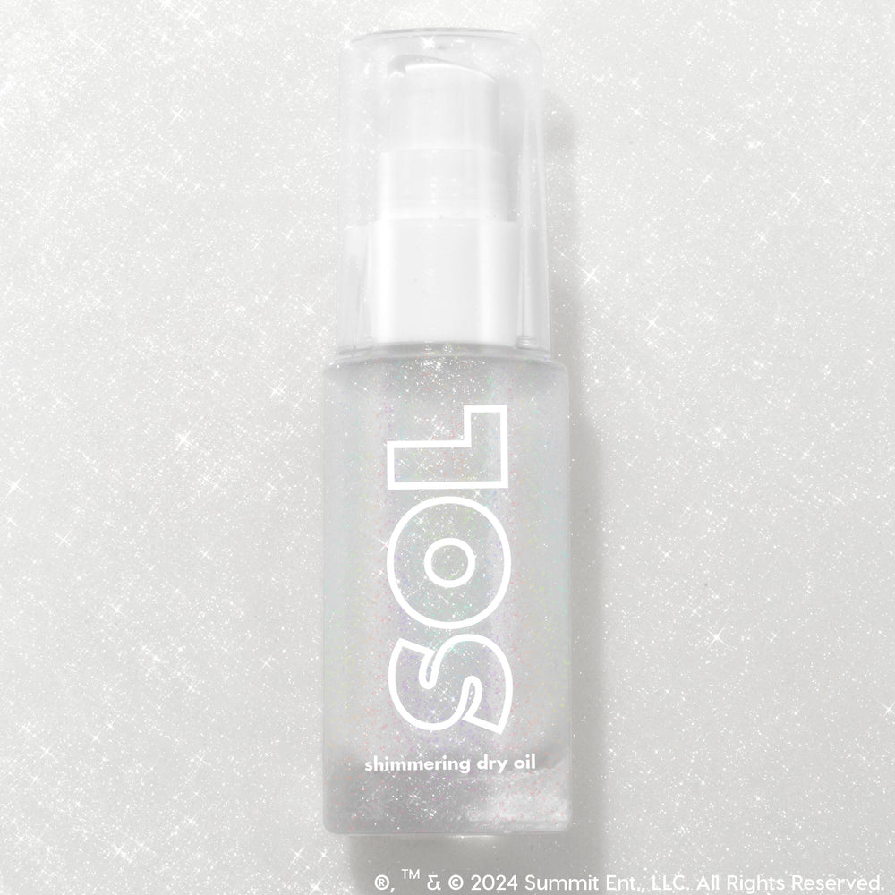Like Diamonds pump bottle displaying iridescent micro-shimmer through frosted glass with bold white SOL logo, ColourPop SOL Shimmering Dry Oil, standing upright on a silver glitter backdrop that enhances the sparkle for a luminous body glow.