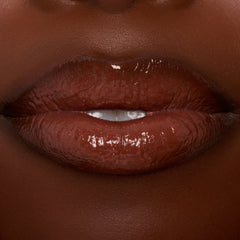 Glossy lips wearing ColourPop Ultra Glossy Lip in Coffee Break, a rich coffee‑brown creme shade, reflecting high shine in a tight close-up studio shot.
