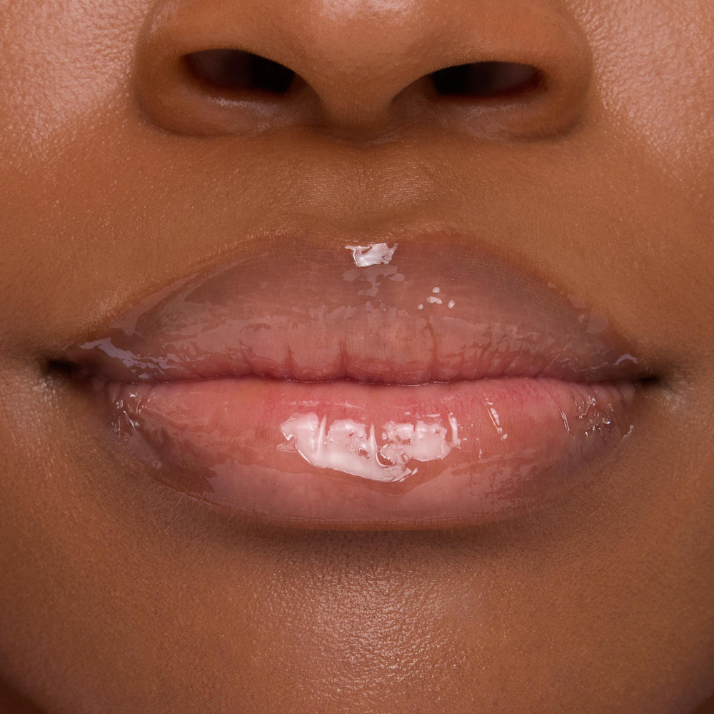Lips wearing ColourPop Lip Mask in Strawberry Milk, gleaming with a sheer pink, high-shine finish in a tight close-up that emphasizes smooth, hydrated texture.