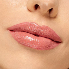 Lips wearing NBD ColourPop Lippie Stix, a warm nude-pink with a creamy, glossy finish, shown in an extreme close-up under studio lighting to display smooth, even coverage and natural shine.