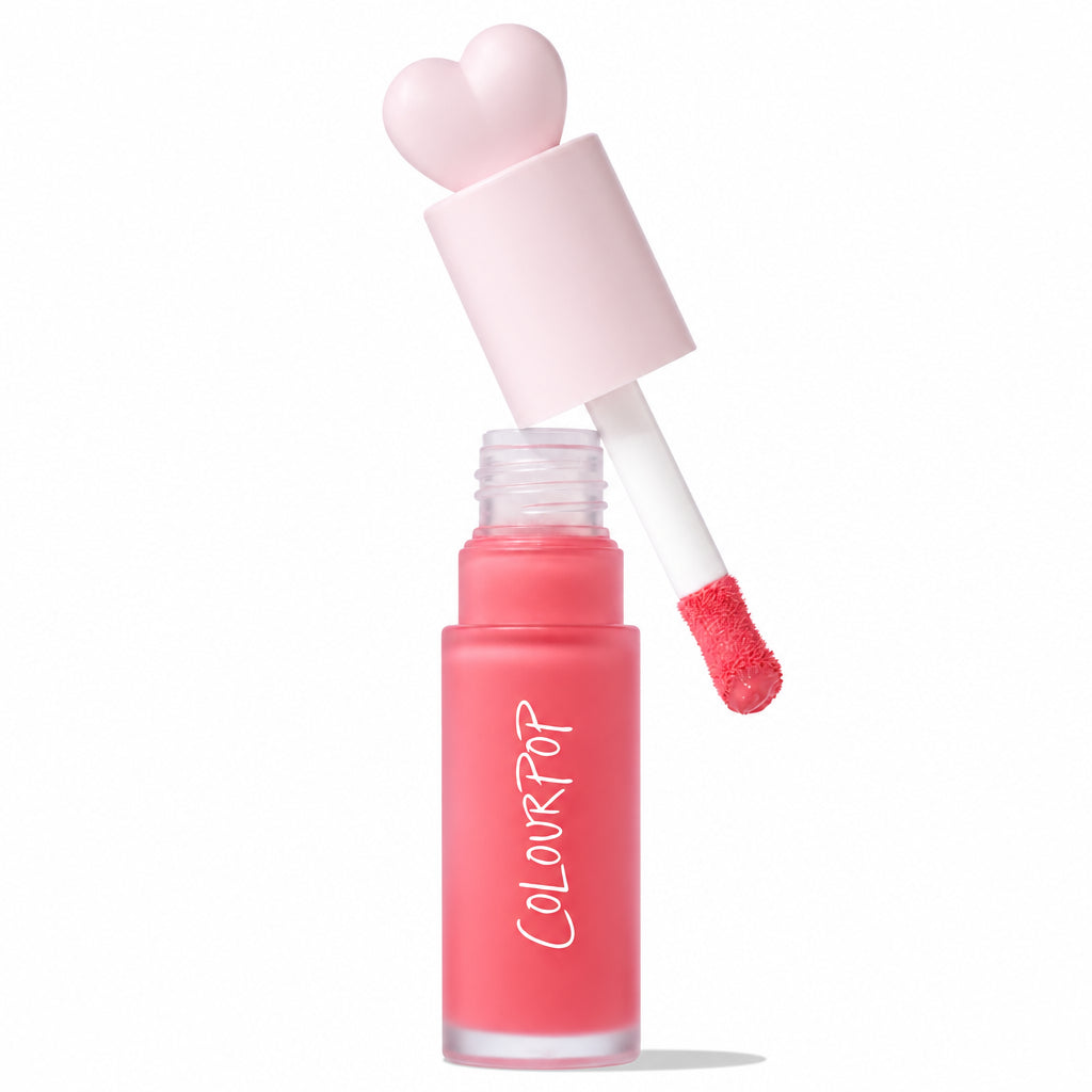 ColourPop Liquid Blush Angel Face shown with doe-foot applicator lifted from a frosted coral-pink bottle, heart-shaped pastel cap, and Allure Best of Beauty 2025 award badge on a white background.