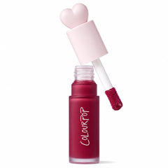 ColourPop Liquid Blush Royal Flush displayed open, doe-foot applicator lifting a berry-red tint from a frosted bottle labeled COLOURPOP, pink heart-shaped cap beside it, with a red Allure Best of Beauty 2025 award badge on a white background.