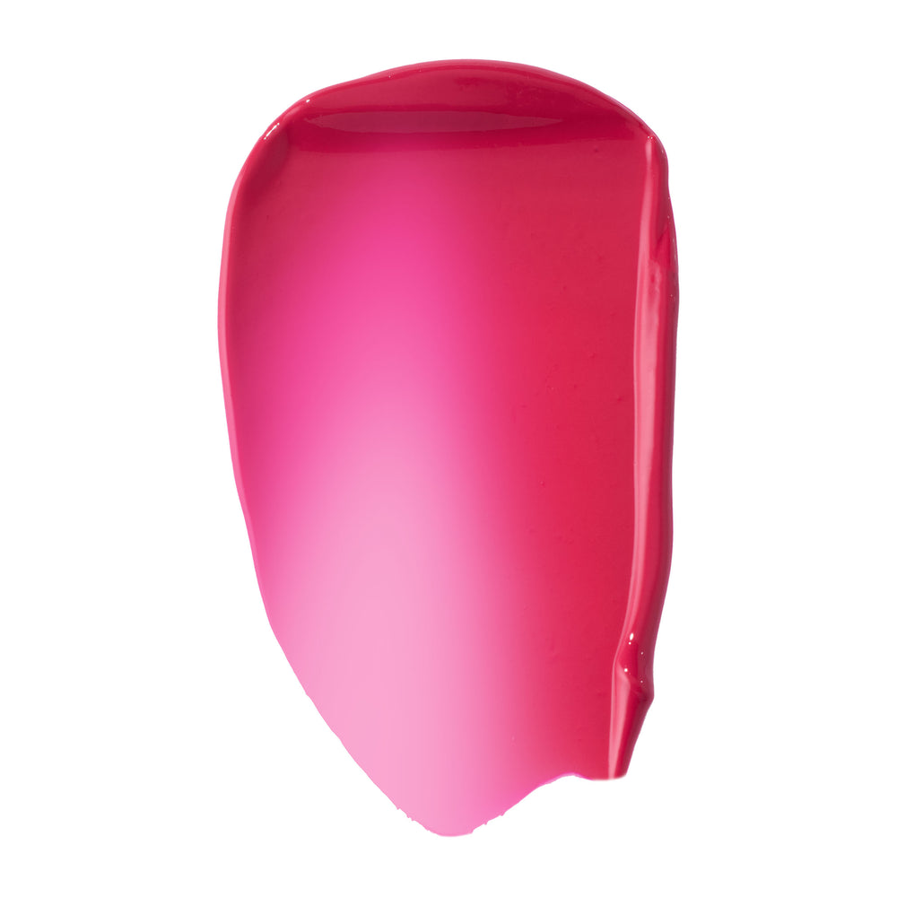 Hot pink fuchsia swatch of ColourPop Liquid Blush, shade Wildest Dreams, smeared in a glossy, high-pigment swipe that fades from sheer light pink center to deeper rosy edges on a clean white background.