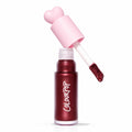 ColourPop Liquid Blush Wine n’ Dine dispenses from an open tube with a pink heart-shaped cap and doe-foot applicator coated in a deep wine, pearly blush, set on a white background with an Allure Best of Beauty 2025 award badge.