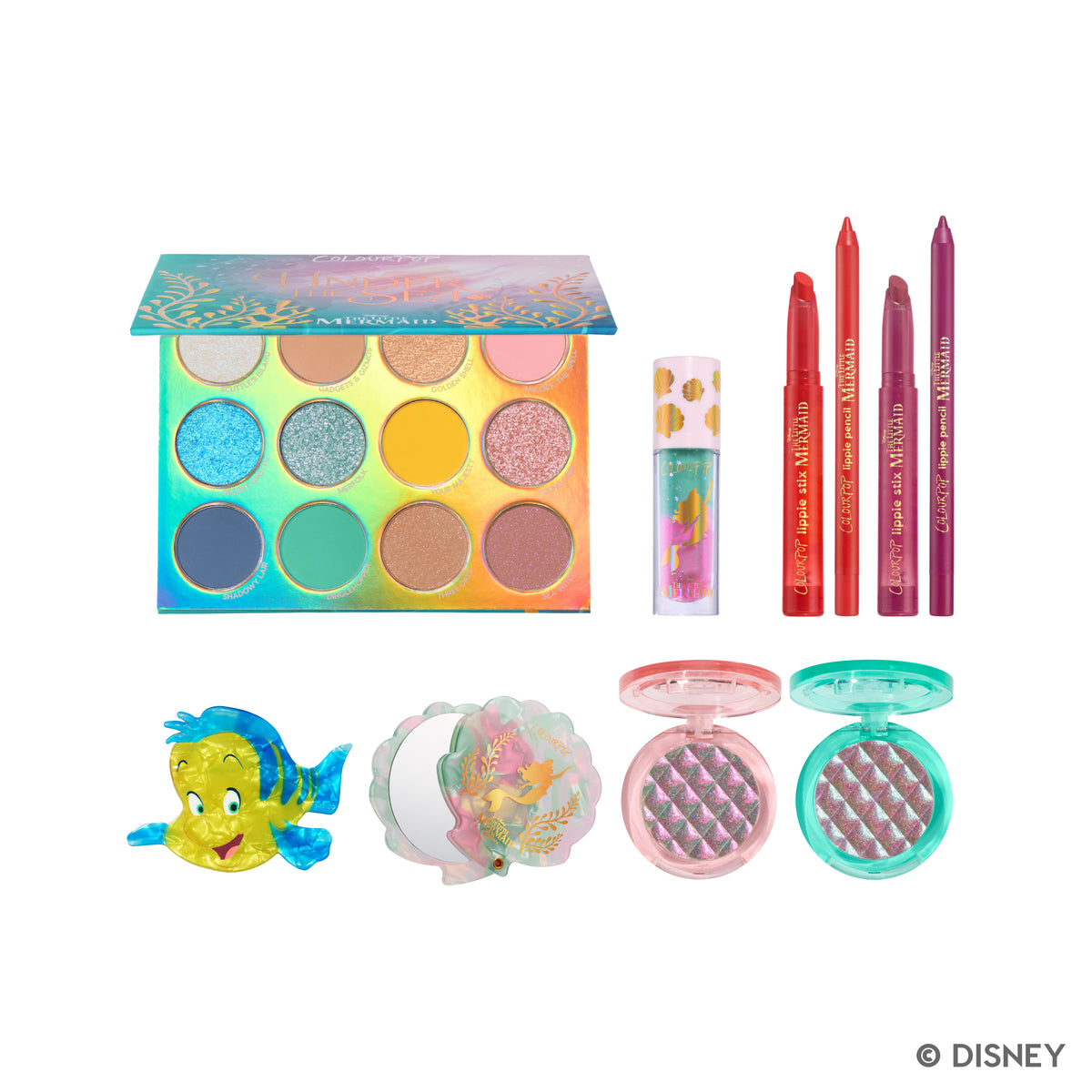 The Little Mermaid collection laid out: Under the Sea palette, lip oil, lip kits, two multichrome highlighters, shell mirror and Flounder hair clip