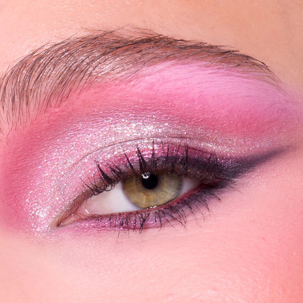 Close-up of a fair-skin eye with pink shadow, silver shimmer and a dark wing from the A Very Mickey Christmas palette