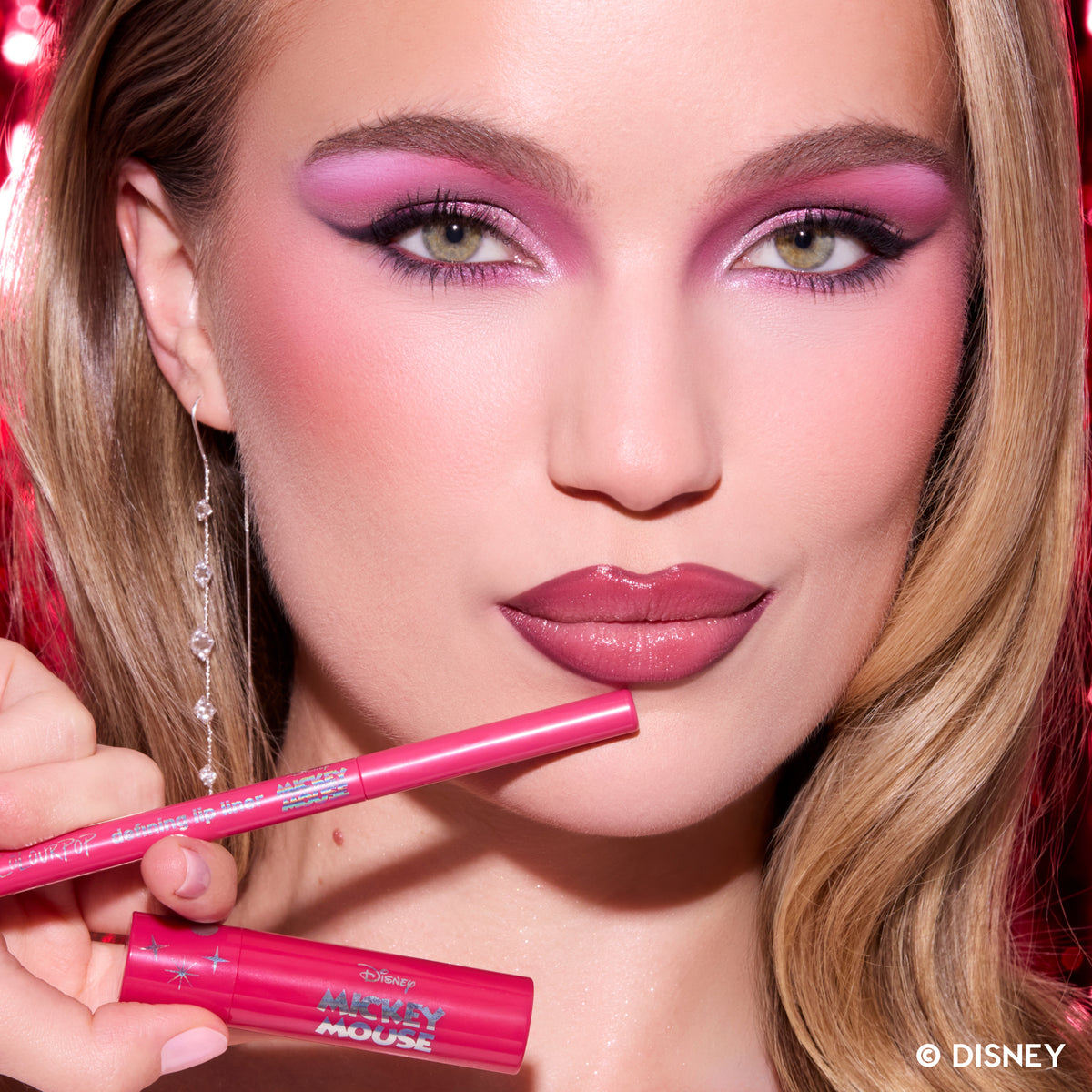 Model wearing the Be Merry & Bright Lip Kit, holding its pink lip liner
