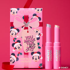 You Made the List kit: two Mickey Mouse Jelly Much Eye Shadow Sticks with their gift-tag box on a red backdrop