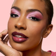 Model with deep skin wearing the Mr. Mickey blackened red lip with pink eyeshadow