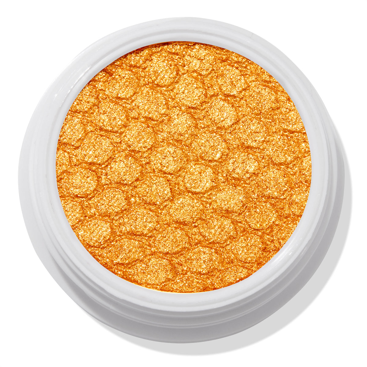 Montecito Super Shock Shadow by ColourPop shimmering in a bold metallic marigold-gold pan, embossed with a honeycomb texture, set in a round white pot against a clean white background.