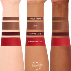 ColourPop Power Pout Lipstick Bella! Where the Hell Have You Been, Loca? swatches display four shades on three skin tones - Hello Biceps (deep brown), Jake (warm brown), Vampire Laws (oxblood), Vampire Royalty (vivid red) - stacked on forearms.