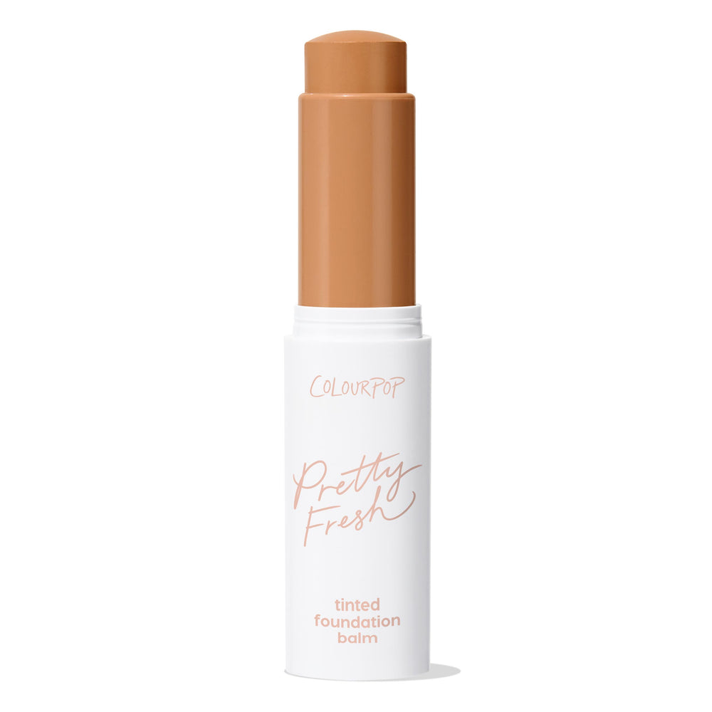 ColourPop Pretty Fresh Tinted Foundation Balm in Dark 17, open twist-up stick showing a warm deep tan shade, standing upright in a white tube with peach “Pretty Fresh” lettering on a clean white background.