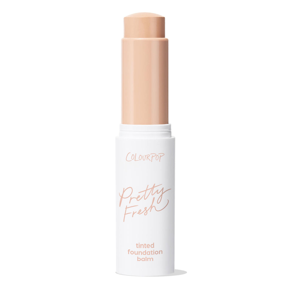 Fair 3 shade of ColourPop Pretty Fresh Tinted Foundation Balm standing open, twist-up stick extended to show a light neutral tone, in a white tube with peach Pretty Fresh lettering, centered on a clean white background.
