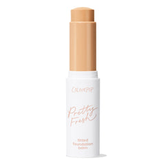 ColourPop Pretty Fresh Tinted Foundation Balm in Medium 9 stands upright with cap off, a creamy warm medium-beige twist-up stick extended from a white tube labeled Pretty Fresh, shown on a clean white background.