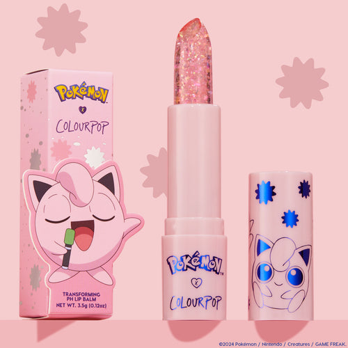 ColourPop pH Lip Balm Sing stands uncapped, revealing a clear glittery bullet beside its pink Pokémon x ColourPop box and matching cap with blue starbursts and Jigglypuff art, set against a pastel pink background.