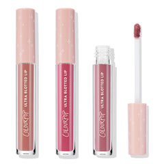 Perfect 4 U ColourPop Ultra Glossy Lip trio stands upright with one tube opened, a doe-foot applicator showing rosy mauve; clear barrels and blush-pink caps with white stars display nude, pink, and mauve shades on a white studio background.