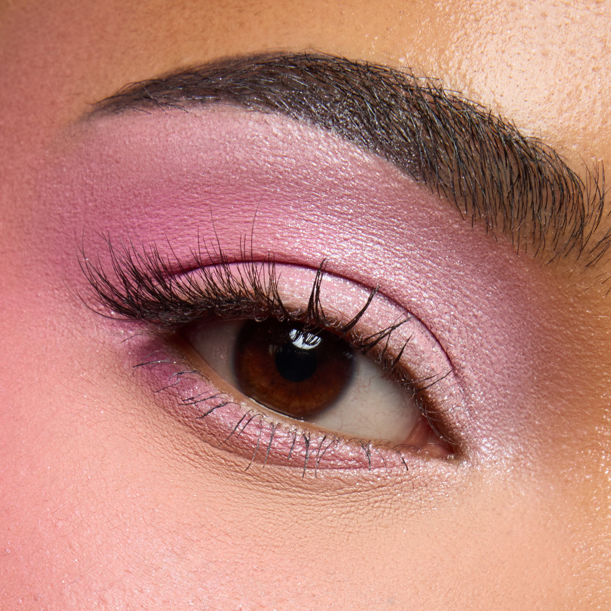 Close-up of a medium-skin eye with cool pink shimmer shadow from the Pink Dreams palette