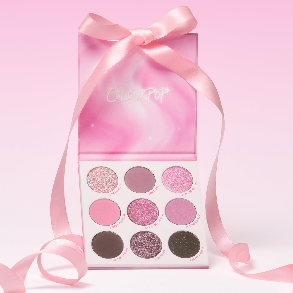 Pink Dreams eyeshadow palette open under its pink ribbon-tied box