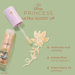 Colourpop Disney Princess Ultra Glossy Lip tube with wand swiping shimmery gold gloss in a floral swirl on a green background, highlighting hyaluronic acid hydration, Kakadu plum vitamin C, and sweet cherry oil softening benefits.