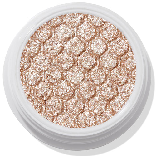 ColourPop Ritz Super Shock Shadow shimmering in a white round pot, its honeycomb-embossed, metallic champagne-beige glitter cream-to-powder formula catching light in a close-up product shot on a clean background.
