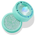 Solar Beam ColourPop Super Shock Shadow sitting open to reveal a sparkling mint-green and pink duochrome eyeshadow, in a mint compact with clear lid and blue COLOURPOP POKÉMON lettering and leaf icon.