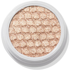 ColourPop Sailor Super Shock Shadow glitters in a close-up, a champagne-beige cream eyeshadow with a honeycomb quilted texture, seated in a white round pot on a clean white background, showcasing its metallic shimmer finish.