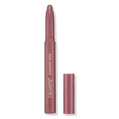 ColourPop Shadow Stix in Next Spot stands uncapped with the rounded shimmer tip exposed, showing a rosy mauve metallic shade; slim pencil with ColourPop Shadow Stix branding, cap beside it on a clean white background.