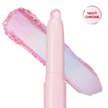 Colourpop Disco Disco Shadow Stix shown uncapped with its shimmery iridescent pink and icy blue eyeshadow swatch smeared diagonally behind the pale pink twist-up stick on a white background.