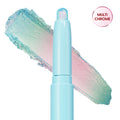 Colourpop Game Over Shadow Stix shown uncapped with a shimmering pastel blue, pink, and green duochrome eyeshadow swatch smeared behind the light blue crayon tube on a white background.