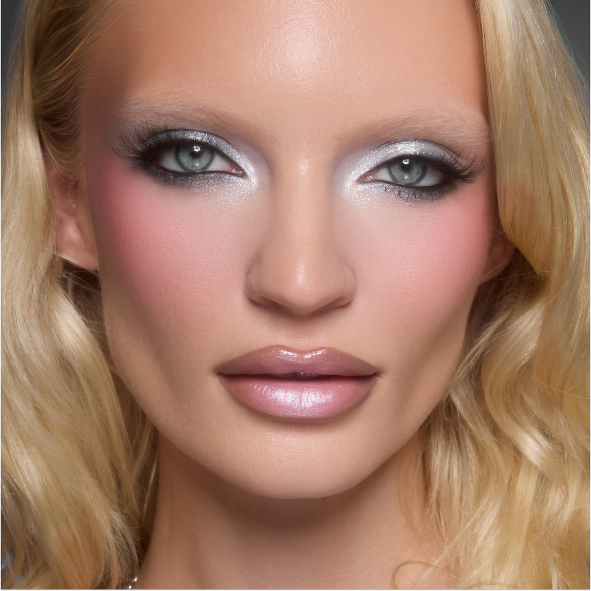 Model with fair skin wearing frosty silver shadow, pink blush and a glossy nude lip from Silver Lining