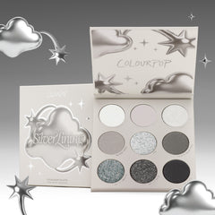 Silver Lining eyeshadow palette open beside its chrome cloud packaging with silver stars
