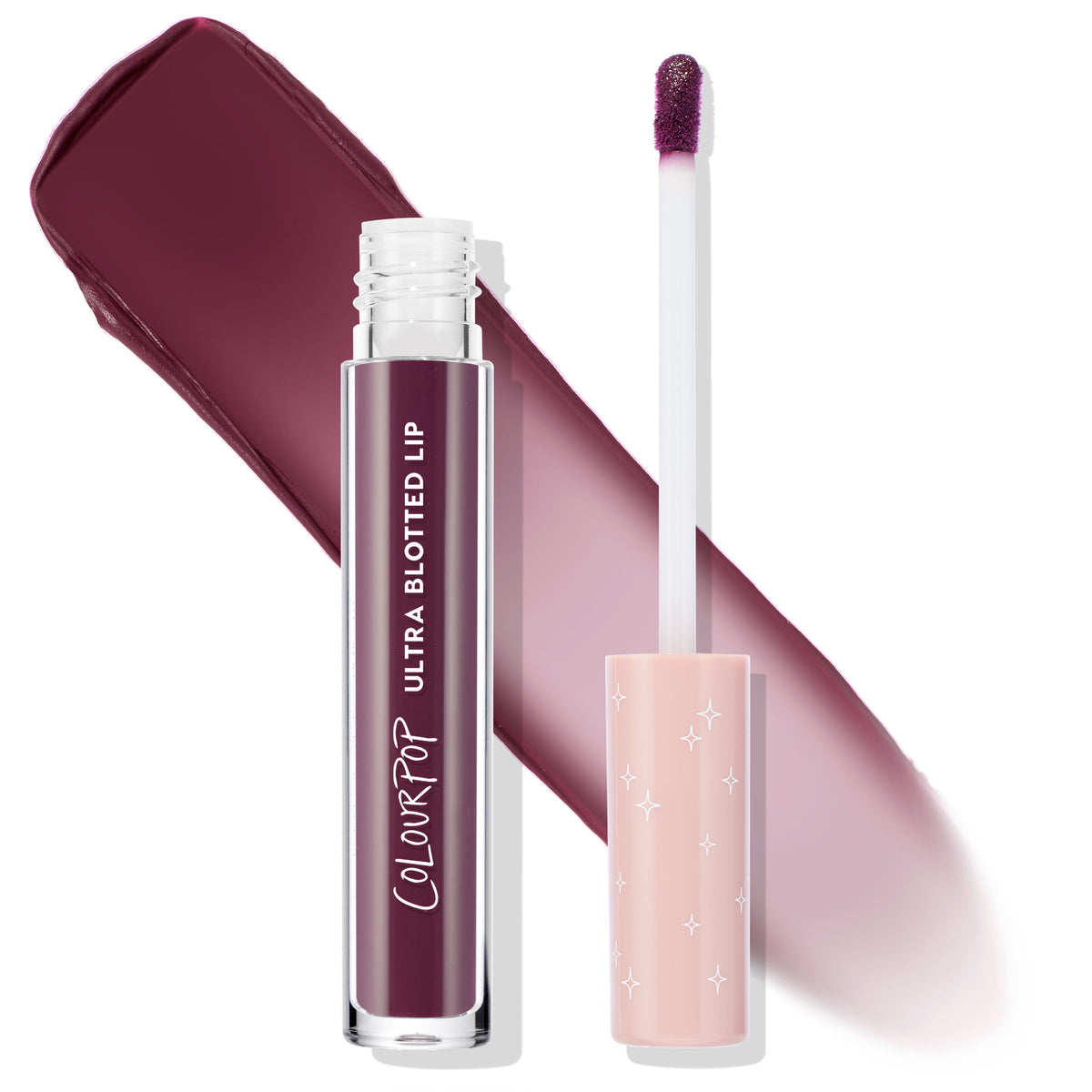 ColourPop Ultra Blotted Lip So Vintage shown open with doe-foot applicator and starry peach cap, clear tube with white logo, and a rich berry‑plum blotted matte swatch behind on a white background.