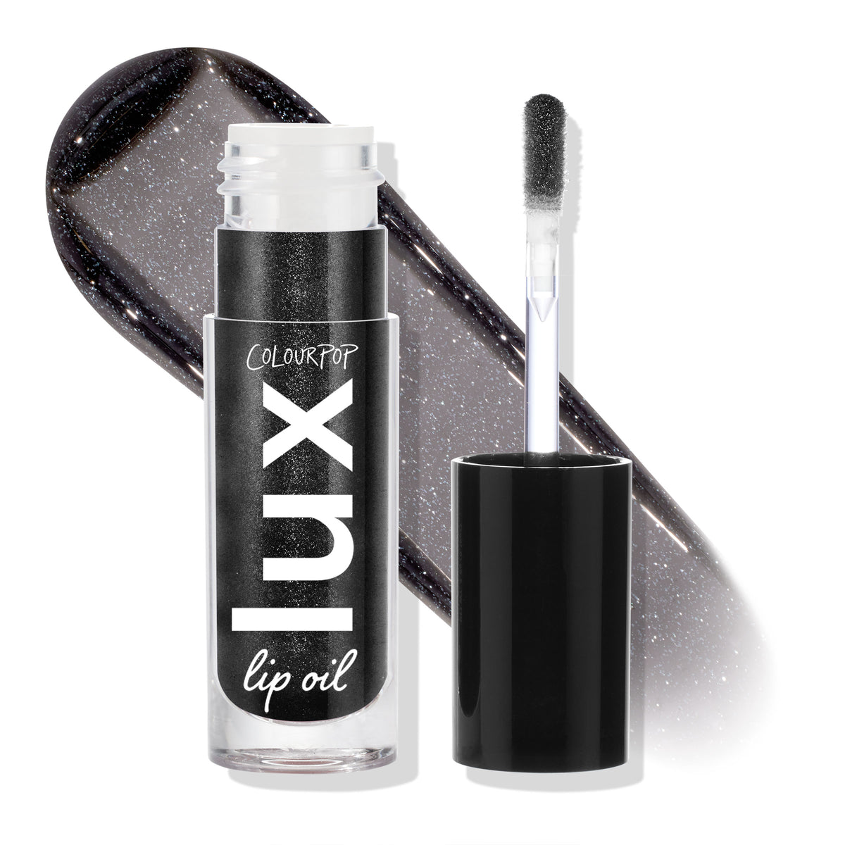 Team Jacob ColourPop Lux Lip Oil displayed open, doe-foot applicator beside the tube and a glossy charcoal-black swatch with silver shimmer behind, highlighting the sheer, high-shine finish; cap off on a white studio backdrop.