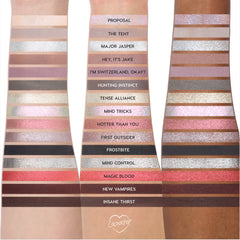 ColourPop Eternal Eclipse eye trio swatched on three skin tones, showing shimmery and matte Twilight-inspired shades like silver, taupe, rose gold, berry, and deep chocolate, arranged in labeled horizontal stripes down each arm.