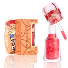 ColourPop Ultra Glossy Lip Yeehaw shows a coral-red, glittery gloss as the doe-foot applicator lifts from the open tube marked Jessie, displayed beside a Disney Pixar Toy Story Jessie–themed box on a bright white background.