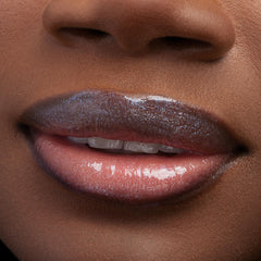 Lips wearing ColourPop Ultra Glossy Lip, Peep This, gleaming with a glassy, high-shine finish and iridescent micro-sparkle; extreme close-up of the mouth highlights smooth, hydrated texture and multidimensional shimmer.