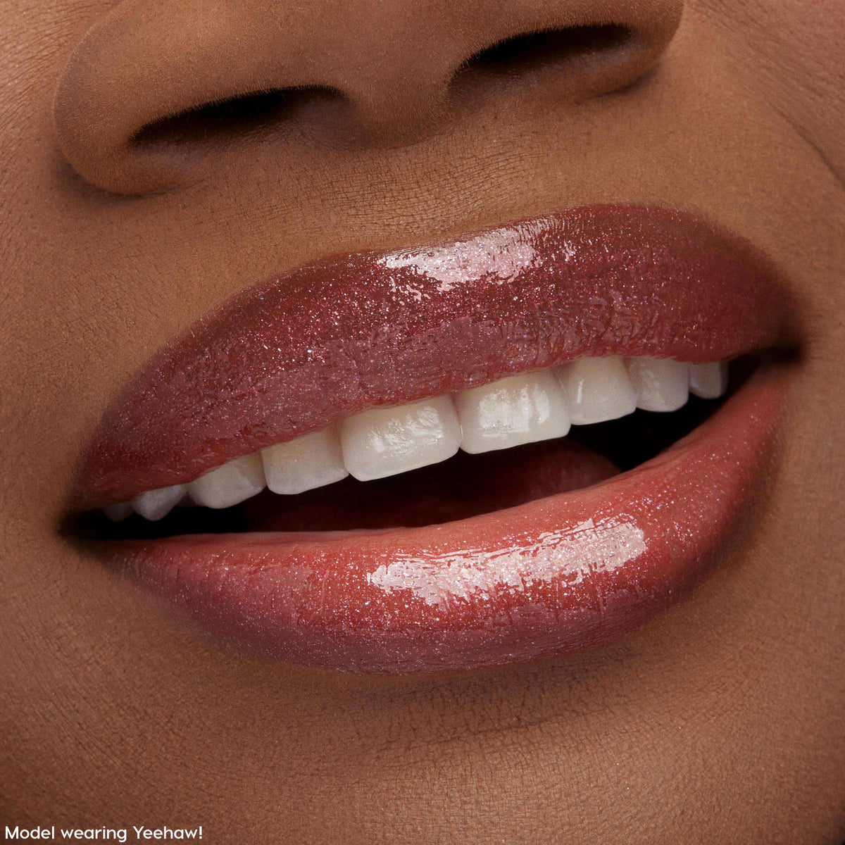 Glossy lips wearing ColourPop Ultra Glossy Lip in Squad Dreams, slightly parted with a soft smile, showcasing a high-shine, sheer rosy tint and fine shimmer in a tight beauty close-up with smooth, hydrated coverage.