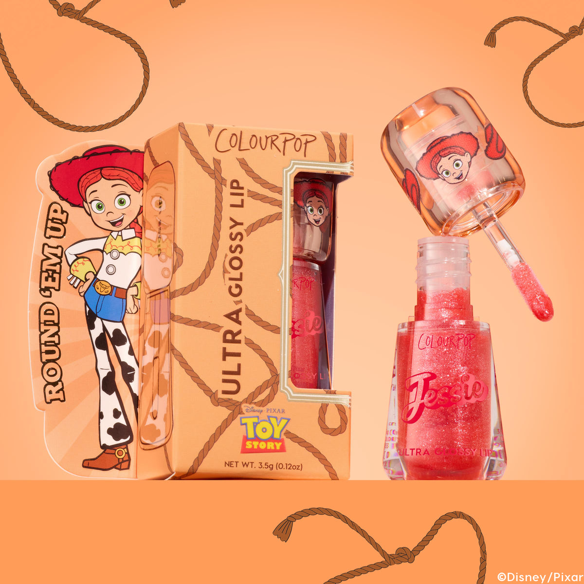 ColourPop Ultra Glossy Lip Yeehaw gloss sparkles in a clear hexagonal bottle as the doe-foot wand lifts peachy-pink shimmer, displayed beside rope-print packaging featuring Toy Story’s Jessie on a warm peach backdrop; 0.12 oz.