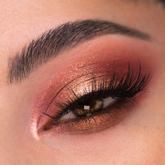 Shimmering rose-gold, copper, and berry eye look blends across the eyelid with a bright inner-corner highlight, showcasing By The Rosé Shadow Palette, a ColourPop Shadow Palette, on smooth skin with full lashes in a close-up.